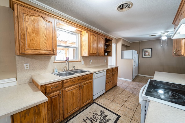 kitchen with open shelves, visible vents, brown cabinetry, a sink, and white appliances