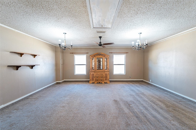 carpeted empty room with crown molding, a textured ceiling, visible vents, and a notable chandelier