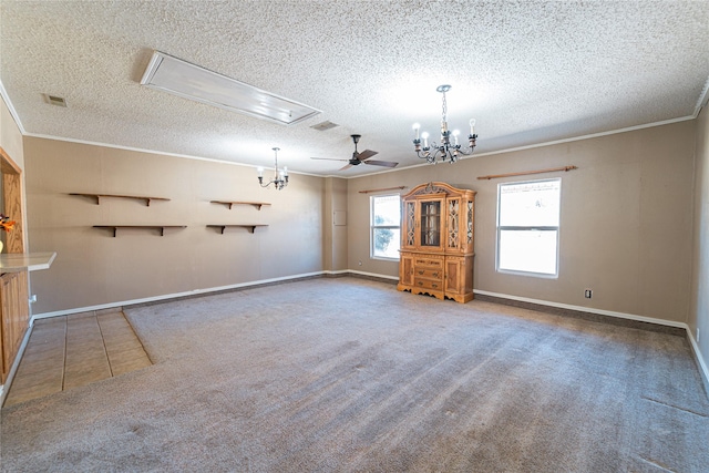 interior space featuring attic access, carpet flooring, crown molding, and a textured ceiling