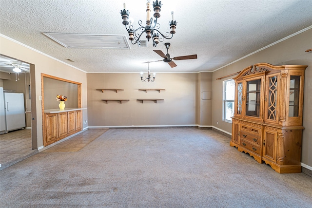 unfurnished dining area with crown molding, carpet flooring, a textured ceiling, baseboards, and ceiling fan with notable chandelier