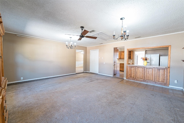 unfurnished living room featuring baseboards, ornamental molding, carpet, a textured ceiling, and ceiling fan with notable chandelier