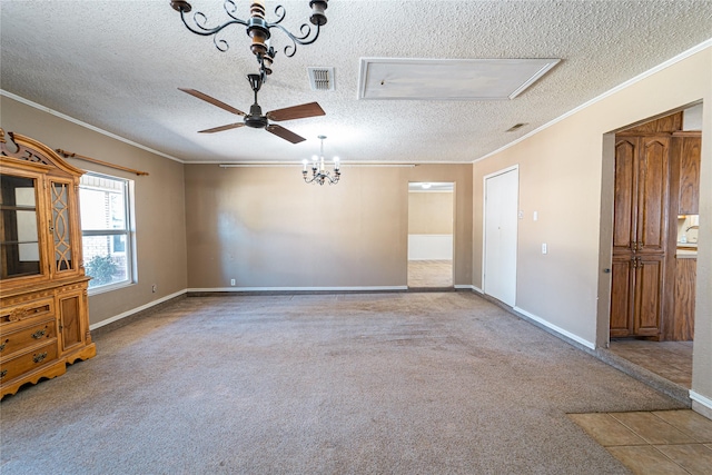 empty room with crown molding, visible vents, carpet flooring, a textured ceiling, and baseboards