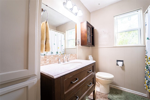 3813 Concord Dr, Abilene, TX 79603 - full bathroom featuring plenty of natural light, vanity, wainscoting, curtained shower, and backsplash