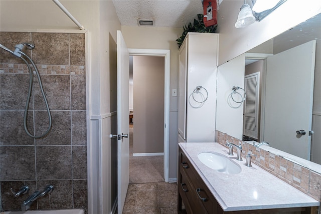 full bathroom with visible vents, a textured ceiling, shower / tub combination, vanity, and baseboards