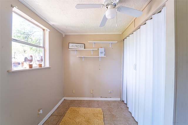 3813 Concord Dr, Abilene, TX 79603 - empty room with a textured ceiling, tile patterned flooring, a ceiling fan, and ornamental molding