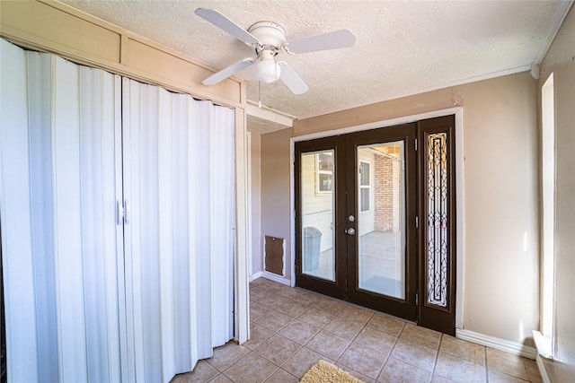 3813 Concord Dr, Abilene, TX 79603 - foyer featuring french doors, light tile patterned floors, a textured ceiling, and ceiling fan