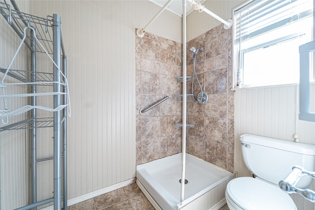 bathroom featuring toilet, a stall shower, and tile patterned flooring