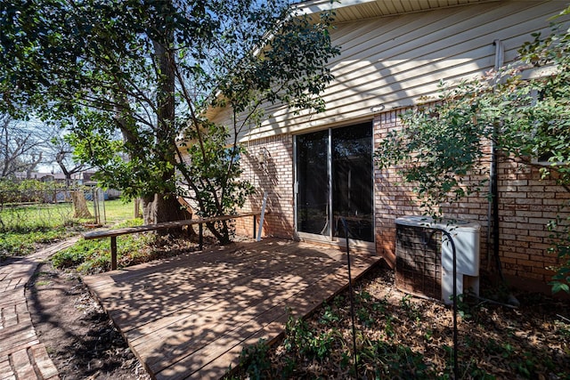 view of patio with central air condition unit, fence, and a wooden deck