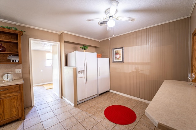 3813 Concord Dr, Abilene, TX 79603 - kitchen with white fridge with ice dispenser, ornamental molding, ceiling fan, light tile patterned flooring, and light countertops