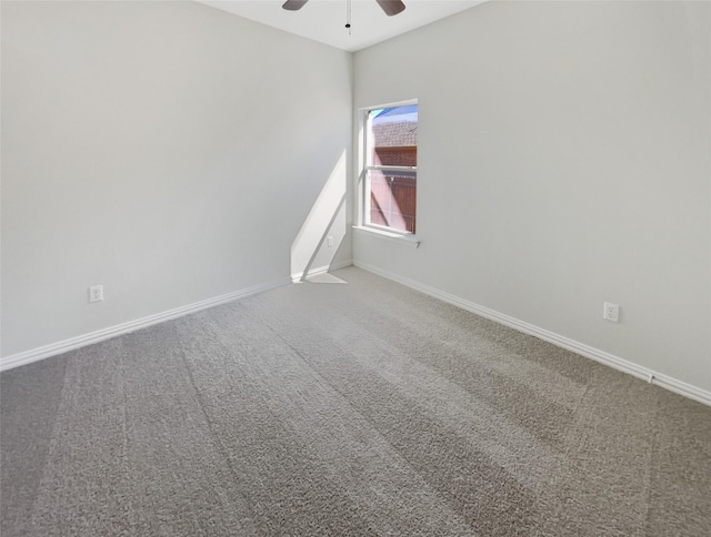 unfurnished room with carpet flooring, ceiling fan, and baseboards