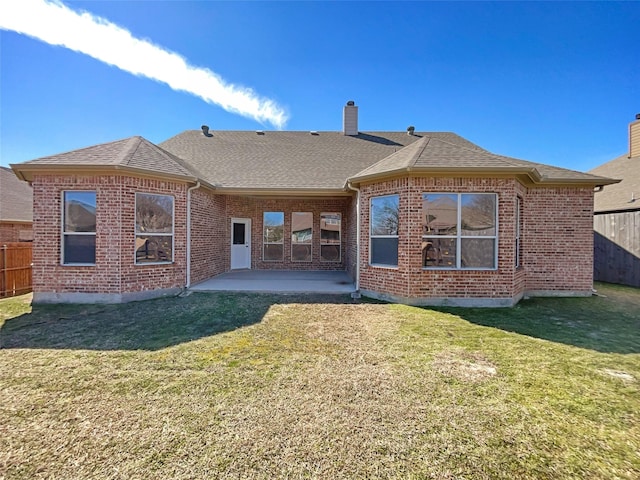 back of house featuring a yard, fence, and a patio