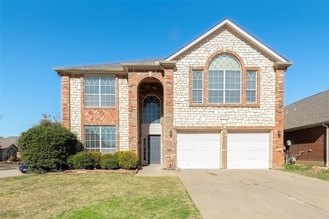 traditional-style home with a garage, a front yard, concrete driveway, and brick siding