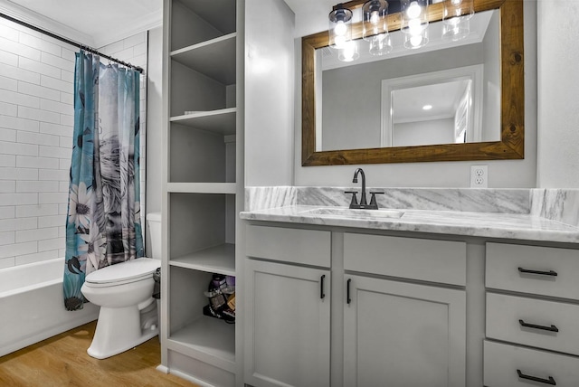 full bathroom with toilet, shower / tub combo, wood finished floors, and vanity