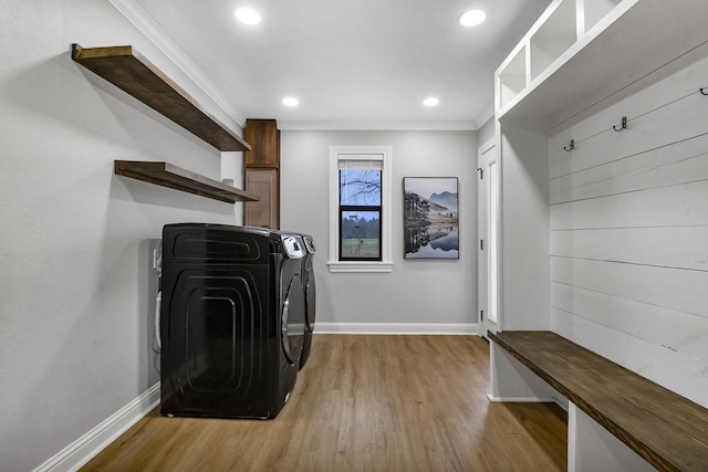 laundry room featuring light wood-style floors, laundry area, crown molding, and baseboards