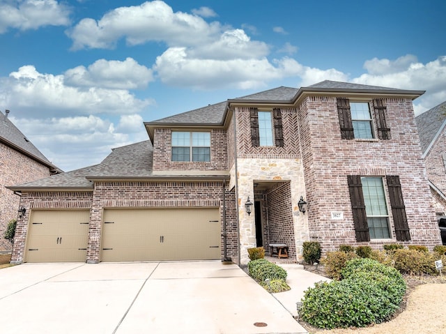 traditional-style home with a garage, concrete driveway, brick siding, and roof with shingles