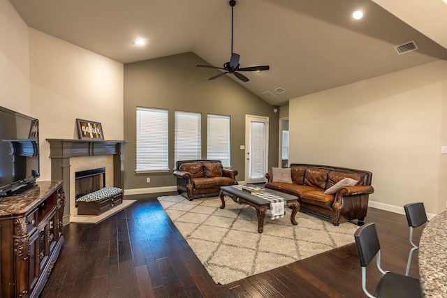 living room featuring a fireplace, visible vents, ceiling fan, wood finished floors, and baseboards