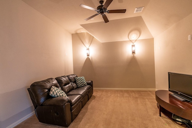 carpeted home theater room featuring vaulted ceiling, a ceiling fan, visible vents, and baseboards