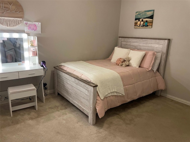 bedroom with baseboards and light colored carpet