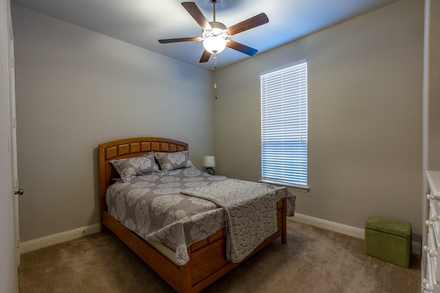 carpeted bedroom with a ceiling fan and baseboards