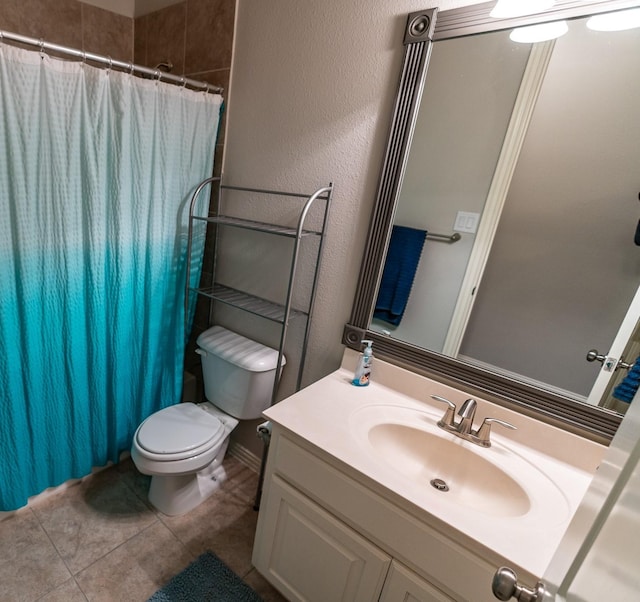 bathroom featuring a textured wall, toilet, a shower with curtain, tile patterned floors, and vanity