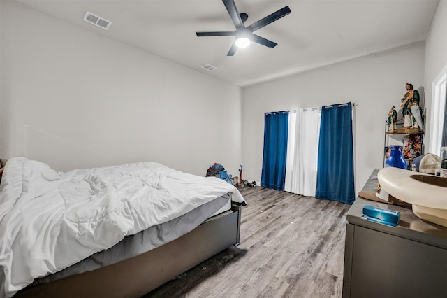 bedroom featuring a ceiling fan, light wood-type flooring, and visible vents