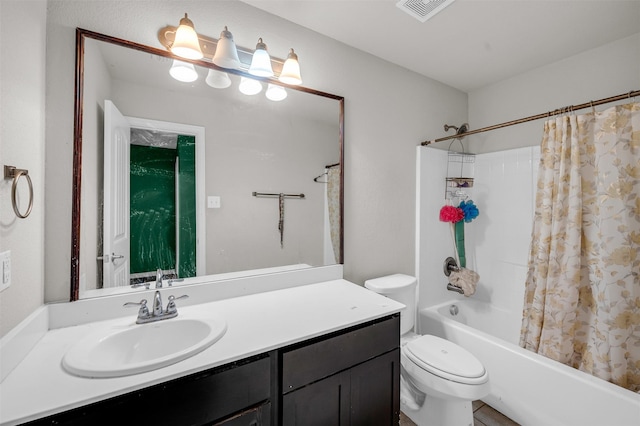 bathroom featuring toilet, vanity, visible vents, and shower / bathtub combination with curtain