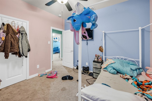 bedroom with light carpet, a ceiling fan, and baseboards