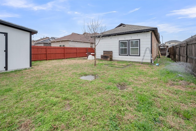 back of property with a yard and a fenced backyard