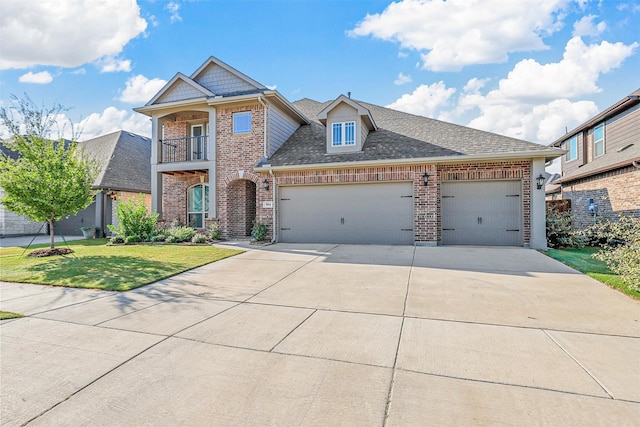 view of front of property with a balcony, a garage, brick siding, driveway, and a front lawn