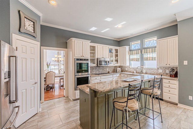 kitchen with glass insert cabinets, a breakfast bar, light stone counters, a center island, and stainless steel appliances