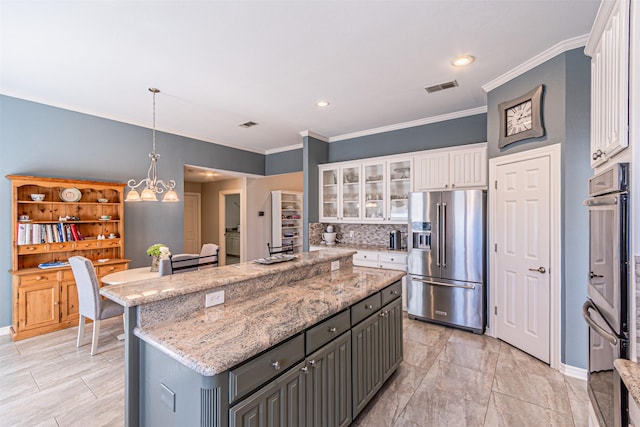 kitchen featuring gray cabinets, appliances with stainless steel finishes, glass insert cabinets, white cabinets, and a kitchen island