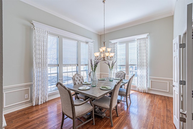 dining space with ornamental molding, a decorative wall, and dark wood-style flooring