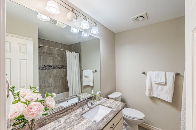 bathroom with shower / bath combo, vanity, and toilet