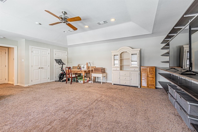 interior space with carpet floors, a tray ceiling, visible vents, and recessed lighting