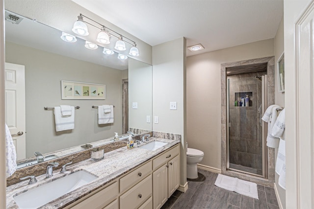 full bath featuring double vanity, wood finish floors, a sink, and visible vents