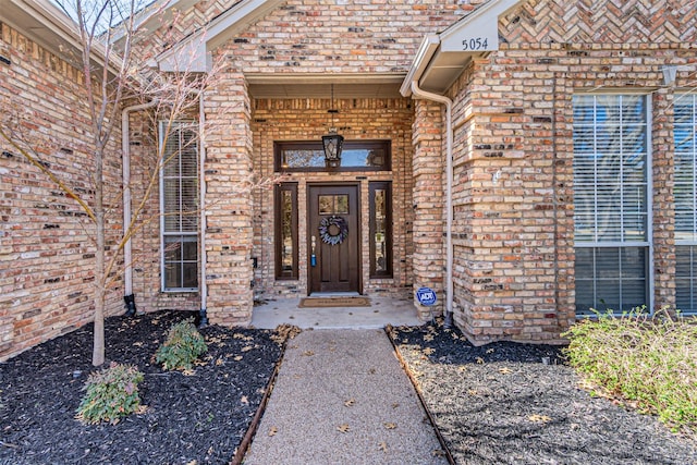 doorway to property with brick siding