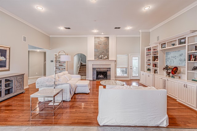 living room with light wood-style floors and ornamental molding