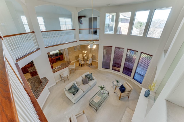 carpeted living area featuring a high ceiling