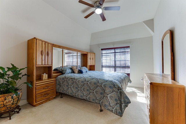 bedroom featuring light carpet, vaulted ceiling, and ceiling fan