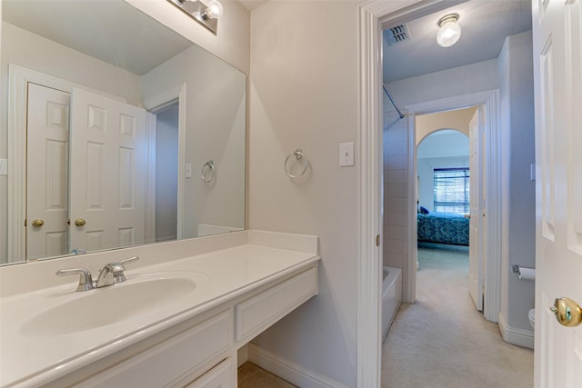 full bathroom with baseboards, visible vents, bathing tub / shower combination, and vanity