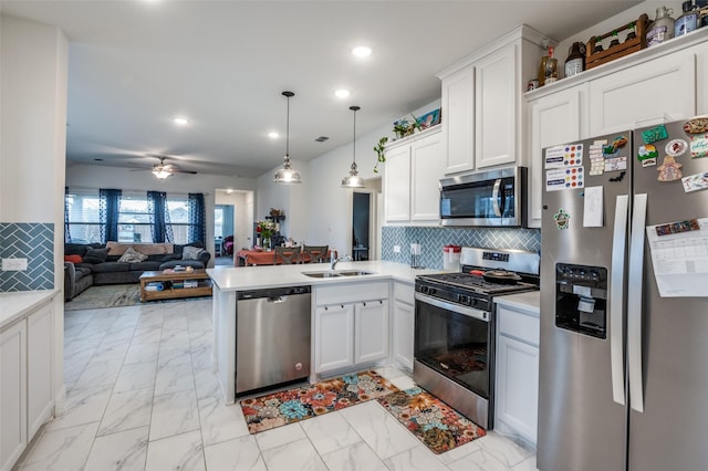 kitchen featuring a sink, open floor plan, marble finish floor, appliances with stainless steel finishes, and decorative light fixtures