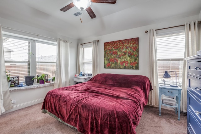 bedroom featuring light carpet, ceiling fan, visible vents, and baseboards