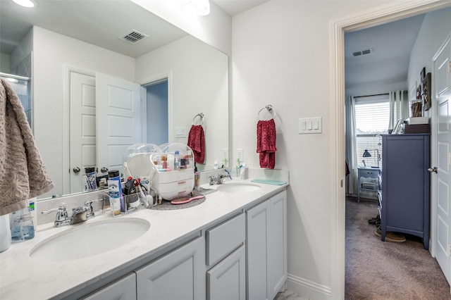 full bathroom featuring double vanity, visible vents, and a sink