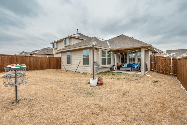 back of house featuring a fenced backyard, an outdoor living space, a shingled roof, and a patio