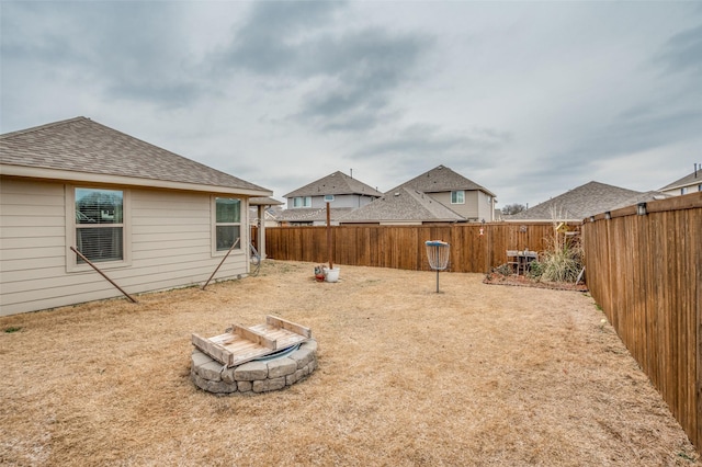 view of yard with an outdoor fire pit and a fenced backyard