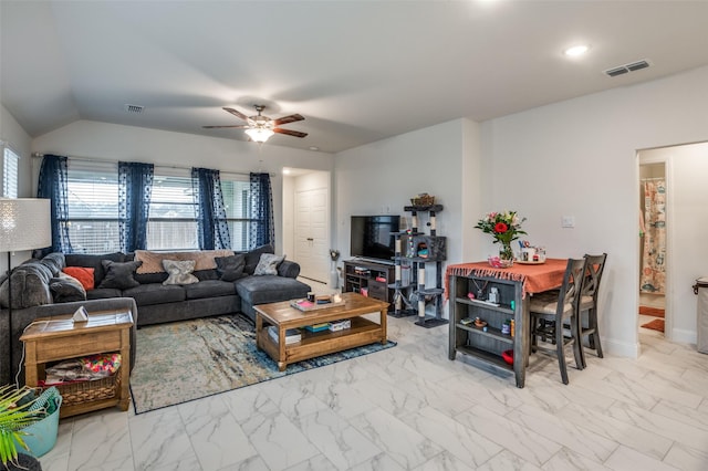 living area with a wealth of natural light, marble finish floor, and visible vents