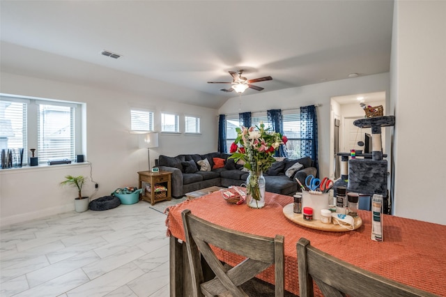 dining room with marble finish floor, plenty of natural light, visible vents, and a ceiling fan