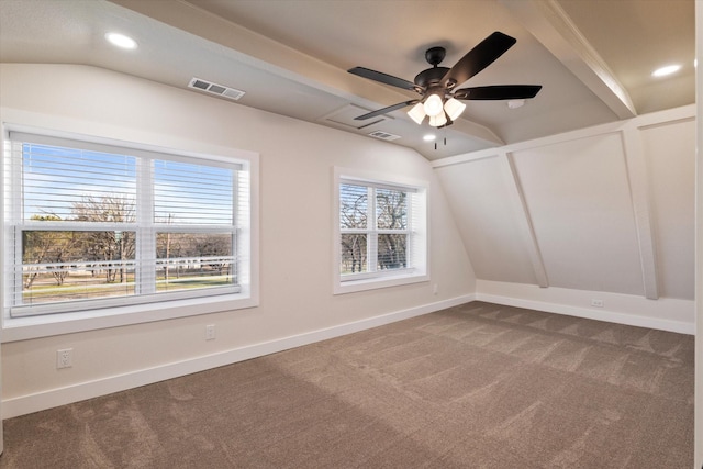 unfurnished room with lofted ceiling, carpet, visible vents, and baseboards