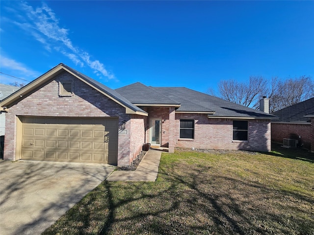 single story home with a garage, driveway, a front lawn, and brick siding