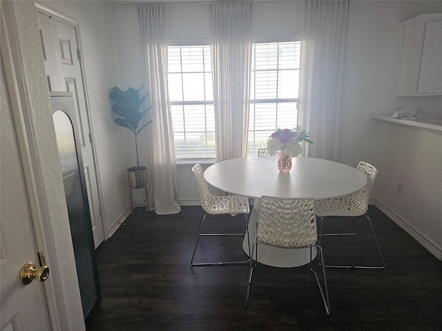 dining space with dark wood-style floors and baseboards